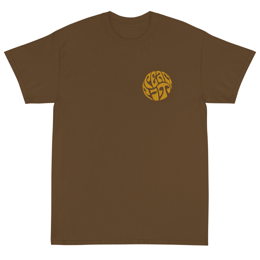 Peach Pit brown short sleeve tee with circular Peach Pit logo on front and rolling design on the back